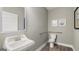 Clean bathroom with a toilet, sink, and grab bar at 667 Edgar # 26, Hampton, GA 30228
