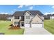 Beautiful two-story home with a three-car garage and landscaped yard at 667 Edgar # 26, Hampton, GA 30228