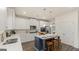 Modern kitchen with white cabinets, island, and stainless steel appliances at 667 Edgar # 26, Hampton, GA 30228
