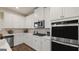 Modern kitchen with white cabinets and stainless steel appliances at 667 Edgar # 26, Hampton, GA 30228