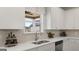 Kitchen with white cabinets, herringbone backsplash, and stainless steel appliances at 667 Edgar # 26, Hampton, GA 30228