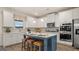 Modern kitchen with white cabinets, island, and double oven at 667 Edgar # 26, Hampton, GA 30228