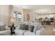 Open living room showcasing kitchen access, plush sofas, and hardwood floors at 667 Edgar # 26, Hampton, GA 30228