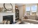 Cozy living room featuring a fireplace, built-in shelving, and large windows at 667 Edgar # 26, Hampton, GA 30228