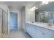 View of the bathroom showing the double vanity, tiled floor, and entry to the shower at 659 Edgar Dr # 24, Hampton, GA 30228