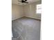 Well-lit bedroom with gray carpeting and a ceiling fan at 95 Grove Creek Dr, Locust Grove, GA 30248