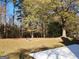 Large backyard with trees and a patio at 98 Gleneagles Dr, Fayetteville, GA 30215