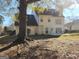 View of house from the backyard with large tree at 98 Gleneagles Dr, Fayetteville, GA 30215
