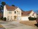 Two story house with attached garage and landscaping at 98 Gleneagles Dr, Fayetteville, GA 30215