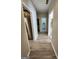 Light-filled hallway with wood-look floors, leading to kitchen and bathroom at 98 Gleneagles Dr, Fayetteville, GA 30215