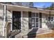 Front entrance with black door and white framed windows at 1471 Cedar Creek Ln, Riverdale, GA 30296