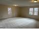 Large bonus room with carpet and windows at 1861 Mcgee Rd, Snellville, GA 30078