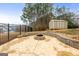 Large backyard patio with fire pit and storage shed at 209 Enfield Ln, Mcdonough, GA 30252