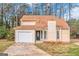 Cute yellow house with a white garage door and landscaping at 1458 Walnut Log Pl, Austell, GA 30168