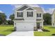 Two-story house with gray siding, white garage door, and landscaping at 458 Prescott Way, Villa Rica, GA 30180