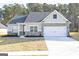 Single story home with gray siding, brick accents, and a two-car garage at 3372 Arabian Farm Ln, Dacula, GA 30019