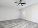 Bedroom with gray wood-look floors, ceiling fan, and a window with blinds at 3060 Azteca Way, Dacula, GA 30019