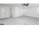 Bright bedroom featuring grey carpet, ceiling fan, and an ensuite bathroom at 3161 Azteca Way, Dacula, GA 30019