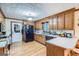 Kitchen with wood cabinets, an island, and hardwood floors at 3871 Nw Laurel Tree Nw Ct, Snellville, GA 30039