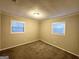 Well lit bedroom with neutral walls and carpet flooring at 10214 Allen Sw Dr, Covington, GA 30014