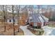 Brick home with attached garage and long driveway, surrounded by mature trees at 240 Edna Ruth Ln, Mcdonough, GA 30253