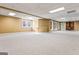 Finished basement with neutral carpet and multiple windows at 240 Edna Ruth Ln, Mcdonough, GA 30253