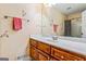 Bathroom with wood vanity, floral wallpaper and shower at 240 Edna Ruth Ln, Mcdonough, GA 30253