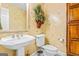 Bathroom with pedestal sink, toilet and decorative wallpaper at 240 Edna Ruth Ln, Mcdonough, GA 30253