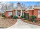 Brick home with a columned porch and landscaped yard at 240 Edna Ruth Ln, Mcdonough, GA 30253