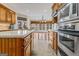 Kitchen with island, stainless steel appliances, and wood cabinets at 240 Edna Ruth Ln, Mcdonough, GA 30253