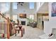 Two-story living room with a fireplace, large windows, and access to other rooms at 450 Meadow Sage Ln, Fayetteville, GA 30214