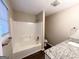 Bathroom with tub/shower combo and granite countertop at 1641 Ne Riverchase Ln, Conyers, GA 30013