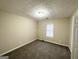 Simple carpeted bedroom with neutral walls and a window with blinds at 1641 Ne Riverchase Ln, Conyers, GA 30013