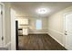 Open concept dining area with vinyl plank flooring and access to the kitchen at 1641 Ne Riverchase Ln, Conyers, GA 30013