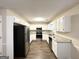 Modern kitchen with white cabinets, granite countertops, and stainless steel appliances at 1641 Ne Riverchase Ln, Conyers, GA 30013
