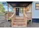 Inviting front porch with wooden steps and railing at 254 Hardy Rd, Brooks, GA 30205