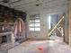 Spacious living room with exposed brick and original fireplace, undergoing renovation at 2004 Joseph E Boone Nw Blvd, Atlanta, GA 30314