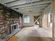 Living room with exposed brick, fireplace and hardwood floors, under renovation at 2004 Joseph E Boone Nw Blvd, Atlanta, GA 30314