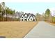 Aerial view of house with driveway and landscaping at 115 Grace Hope Dr, Brooks, GA 30205