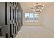 Spacious dining room featuring a modern chandelier and dark accent wall at 115 Grace Hope Dr, Brooks, GA 30205