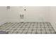 Laundry room with patterned tile floor and built-in utility sink at 115 Grace Hope Dr, Brooks, GA 30205