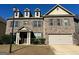 Charming brick two-story home featuring a covered entrance and two-car garage at 566 Mariposa Ln, Mcdonough, GA 30253