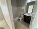 Bathroom with a shower-tub combo, tile floors, and built-in storage at 566 Mariposa Ln, Mcdonough, GA 30253