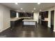 Spacious kitchen with dark cabinets, granite countertops, and stainless steel appliances at 566 Mariposa Ln, Mcdonough, GA 30253