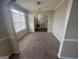 Dining room with carpet, archway and view of stairs at 7921 Chadwick Ln, Riverdale, GA 30274