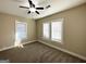 Bright and airy bedroom with neutral carpeting and large windows at 555 Holly Nw St, Atlanta, GA 30318