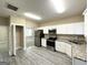 Updated kitchen with white cabinets, granite countertops, and stainless steel appliances at 555 Holly Nw St, Atlanta, GA 30318