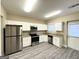 Modern kitchen with white cabinets, granite countertops, and stainless steel appliances at 555 Holly Nw St, Atlanta, GA 30318