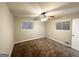 Bright bedroom with neutral walls, carpet, and two windows at 1908 Delowe Sw Pl, Atlanta, GA 30311