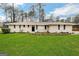 Ranch style home with brick facade, and a well-manicured lawn at 1908 Delowe Sw Pl, Atlanta, GA 30311